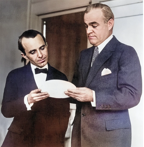 Figure 1. “Director of the Mint, Raymond T. Baker (right) and Anthony de Francisci examining model of the new silver dollar, the first of which will be issued by January 1st.” (Photo and caption by National Photo Company, courtesy Library of Congress.)