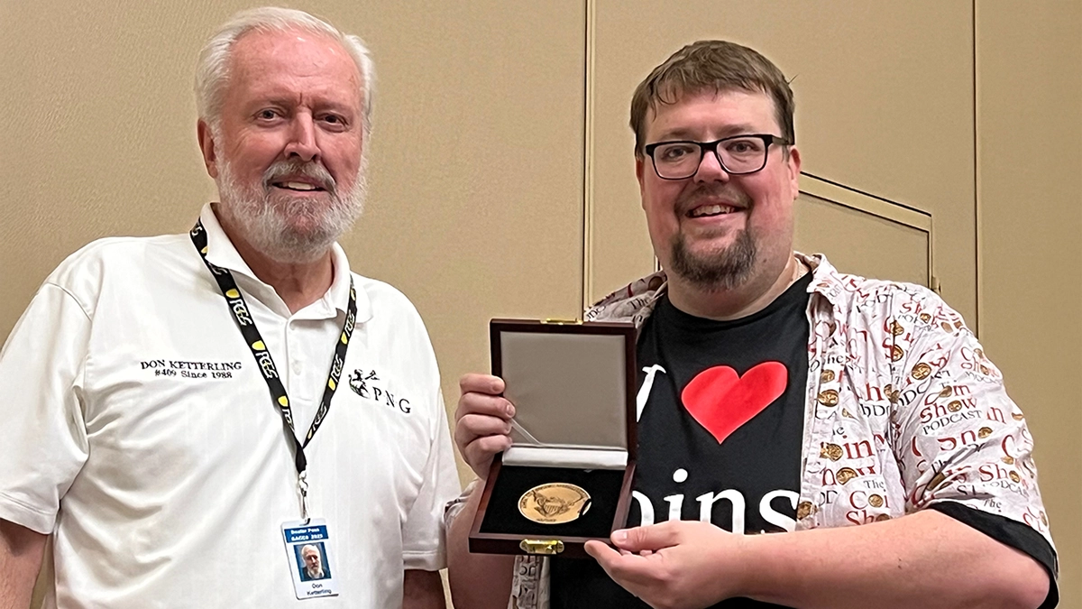 This is an image of ACEF Board member Don Ketterling, left, congratulates Matt Dinger, right, 2025 Alan Kruezer Award medal recipient.