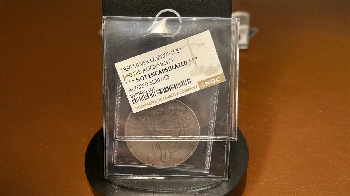 This is an image of an NGC bodybagged fake 1836 Gobrecht Dollar.